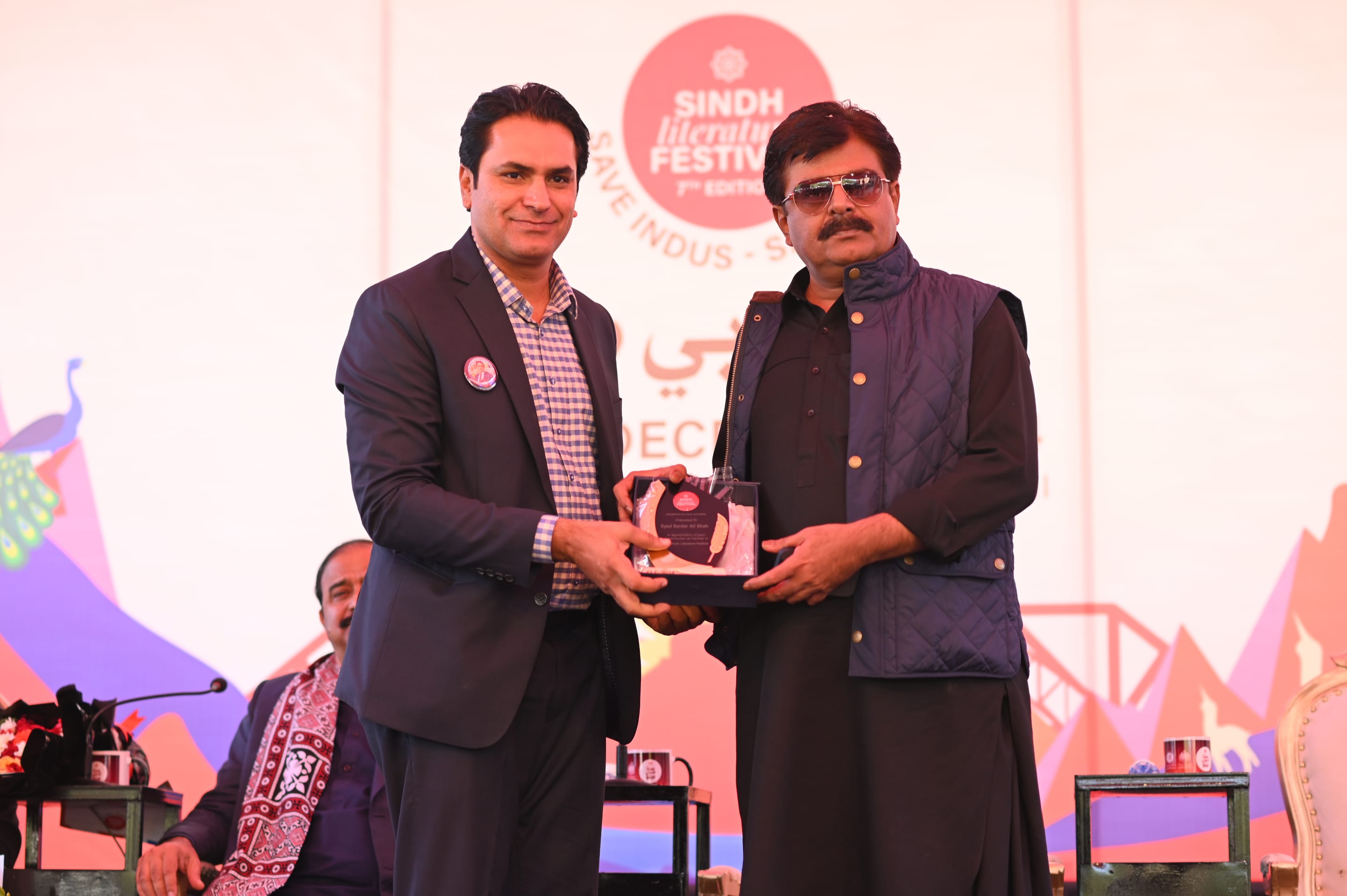 An awardee receiving the Safeer-e-Sindh Award on stage